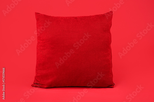 Stylish pillow on red background