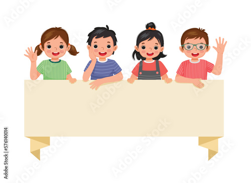 Happy children boys and girls standing behind blank banner board waving hands