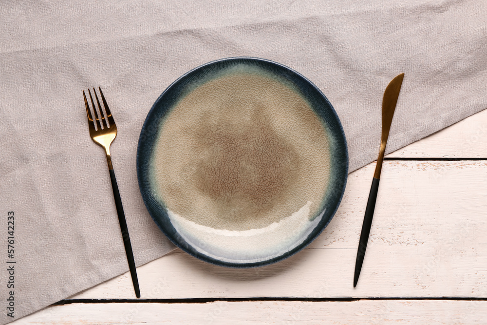 Plate, fork and knife on white wooden background Plate, fork and knife on white wooden background