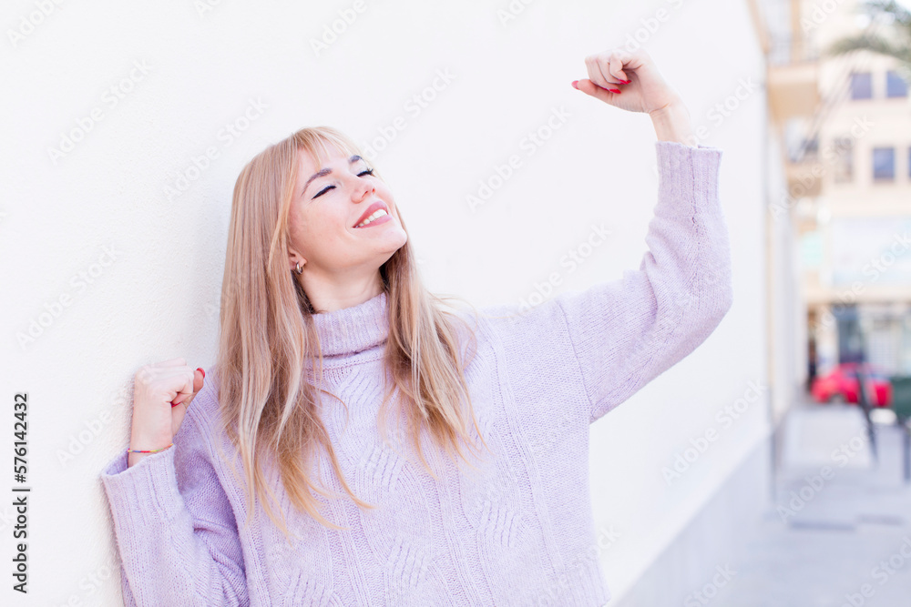 young pretty woman feeling happy, positive and successful, celebrating victory, achievements or good luck young pretty woman feeling happy, positive and successful, celebrating victory, achievements or good luck