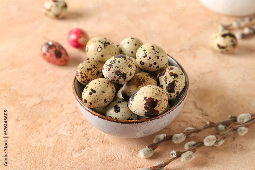 Bowl with Easter quail eggs on beige table Bowl with Easter quail eggs on beige table