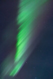 Beautiful bright curtains of Aurora Borealis Northern Lights seen in Yukon Territory with green, purple and pink tones. 