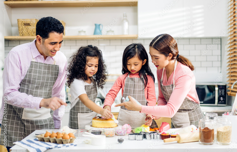 Portrait of enjoy happy love asian family father and mother with little asian girl daughter child play and having fun cooking food together with baking cookie and cake ingredient in kitchen Portrait of enjoy happy love asian family father and mother with little asian girl daughter child play and having fun cooking food together with baking cookie and cake ingredient in kitchen
