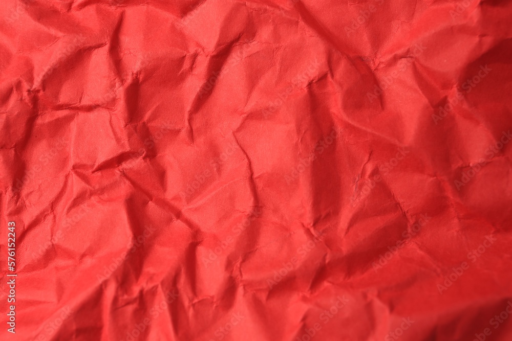 Sheet of crumpled red paper as background, top view Sheet of crumpled red paper as background, top view