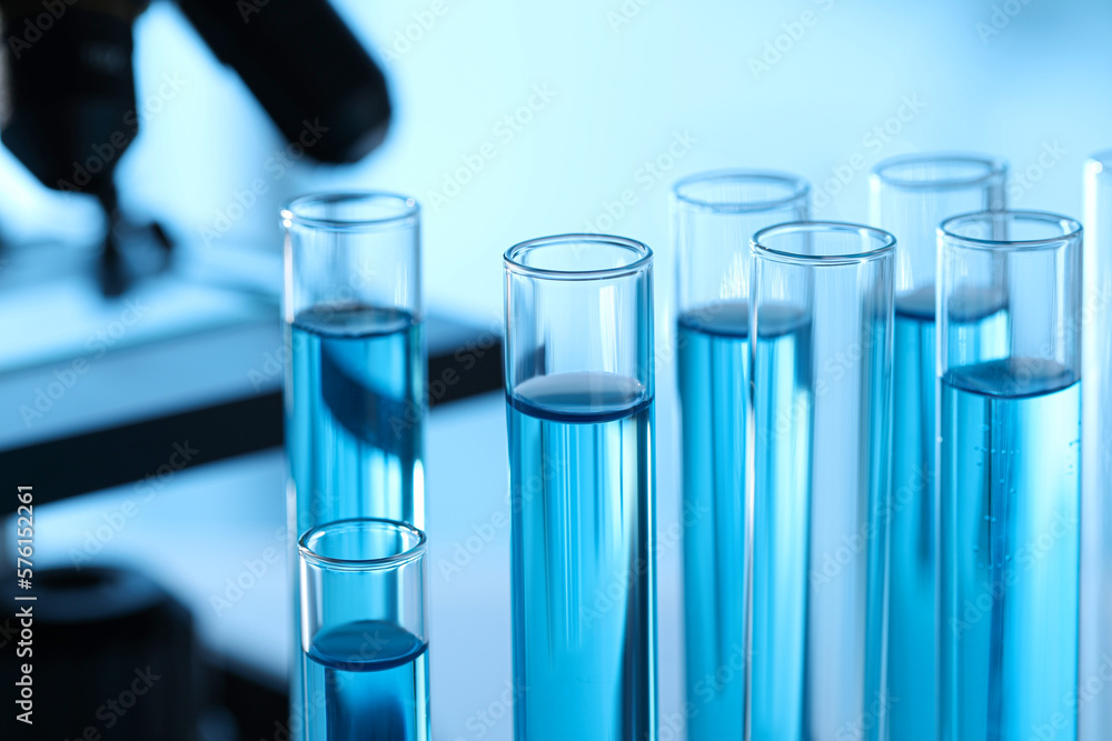 Test tubes with light blue liquid in laboratory, closeup Test tubes with light blue liquid in laboratory, closeup