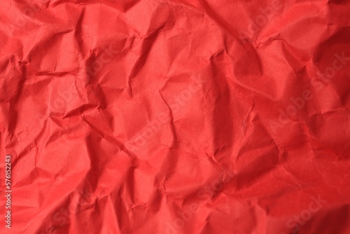 Sheet of crumpled red paper as background, top view