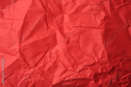 Sheet of crumpled red paper as background, top view