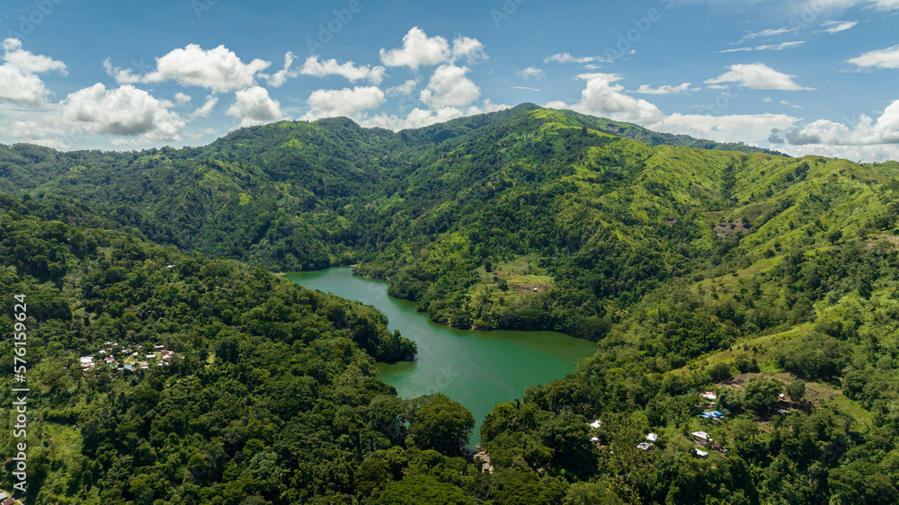 A beautiful lake among the mountains with tropical vegetation. Lake Balanan. Negros, Philippines