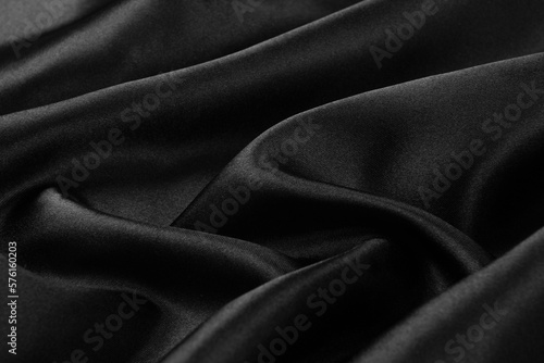 Smooth elegant black silk or satin luxury cloth texture background.