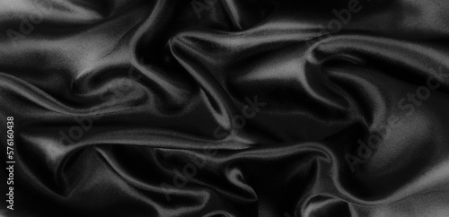 Smooth elegant black silk or satin luxury cloth texture background.