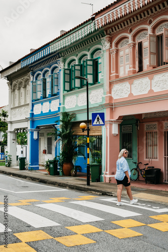 Photography Woman on the crosswalk in front of the colourful houses of Koon Seng Road in Sin