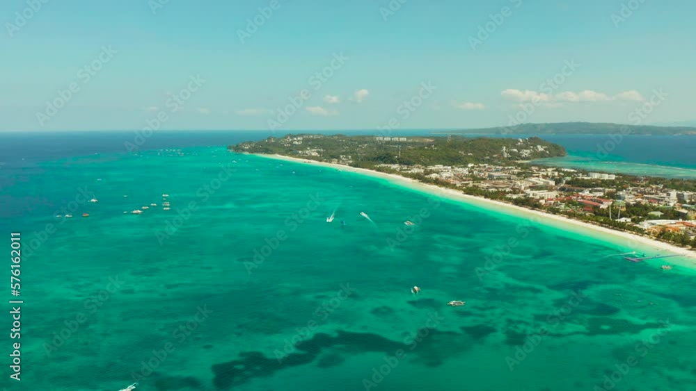 Travel concept: sandy tropical beach with hotels and tourists near the blue lagoon, aerial view, Boracay, Philippines. Seascape with beach on tropical island. Summer and travel vacation concept. Travel concept: sandy tropical beach with hotels and tourists near the blue lagoon, aerial view, Boracay, Philippines. Seascape with beach on tropical island. Summer and travel vacation concept.