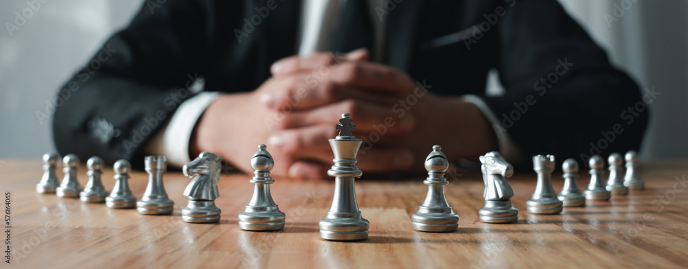 young businessman Asian man sitting holding hands looking at the chess set, strategy concept, and business tactic. Business plan. Teamwork. success management or leadership concepts. - obrazy, fototapety, plakaty 