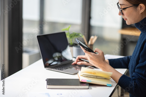 Businessman working at office with calculator documents phone laptop on desk, Asian woman doing planning analyzing the financial report, business plan investment, finance analysis concept