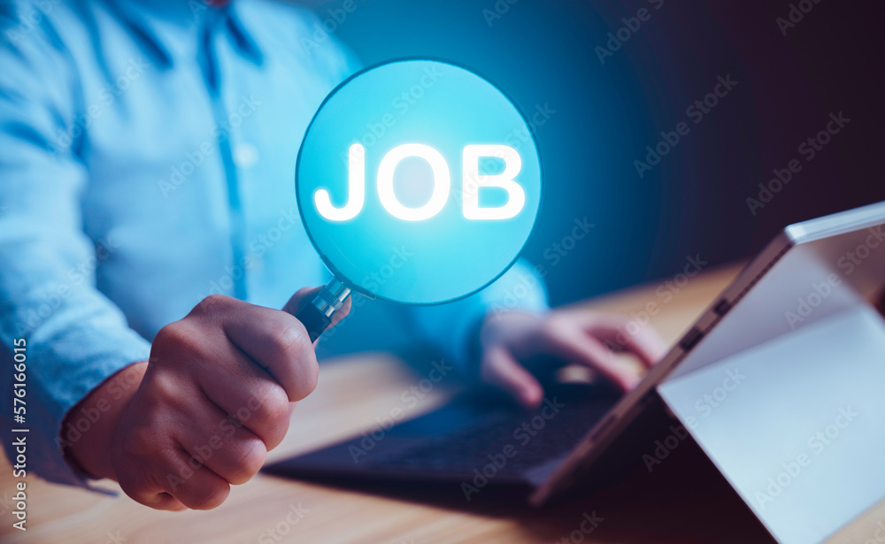 Businessman holding magnifier to search and browsing work opportunities online job search computer app. HR job, internet technology, searching information, find your career and recruitment concept. Businessman holding magnifier to search and browsing work opportunities online job search computer app. HR job, internet technology, searching information, find your career and recruitment concept.