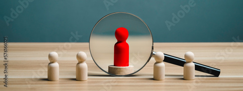 The magnifier finding and choosing red wooden figure. leaders for business success, Leadership, Personnel selection and competition. Job human resources for teamwork. Target customer. manager or CEO.