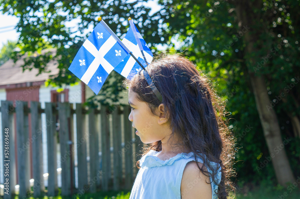 Fototapeta premium Girl celebrates the national holiday, Drapeau québec - Happy Quebec Day Quebec's National Holiday, La Fete Nationale du Quebec, St. Jean-Baptiste
