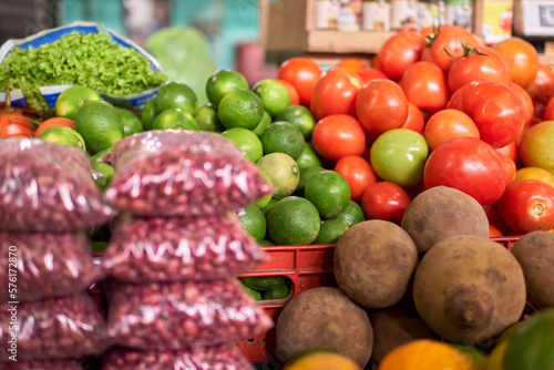 beans  lemons  tomatoes and sapote displayed at market vegetable stand counter