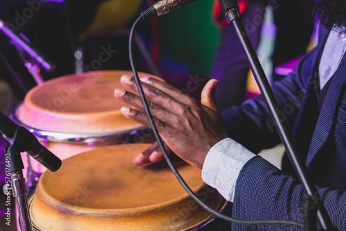Billede på lærred Bongo drummer percussionist performing on a stage with conga drums set kit durin
