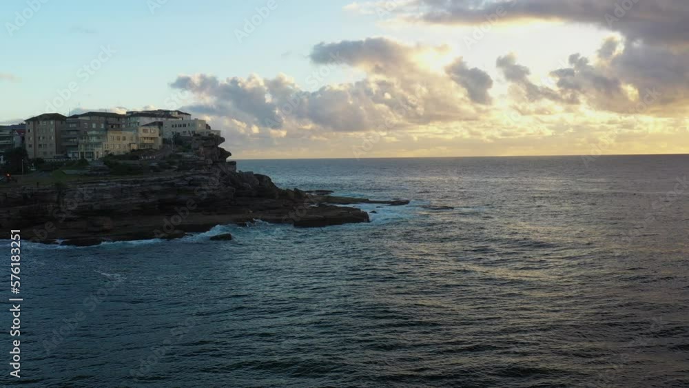 Drone shot of North Bondi during a beautiful golden sunrise. Tracking to the left Drone shot of North Bondi during a beautiful golden sunrise. Tracking to the left