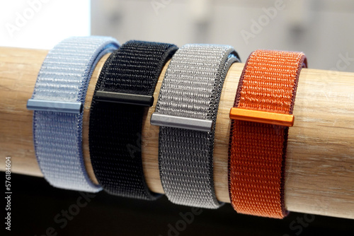 colorful wrist watch straps. Nylon strap  for electronic watches, on a wooden stand.       photo