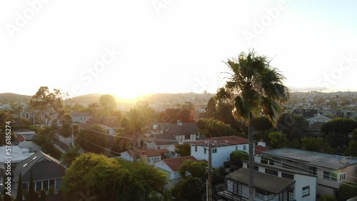 Aerial over neighborhoods in town of Orange, California at sunset photo