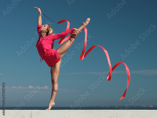 woman rhythmic gymnast with red ribbon
