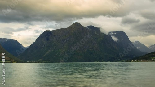 Clouds over Strynsvatnet lake and dramatic mountains in Norway photo