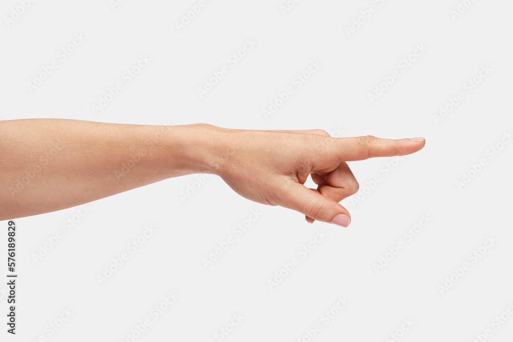 Woman's hand pointing to the right with the index finger. Woman's hand pointing to the right with the index finger.