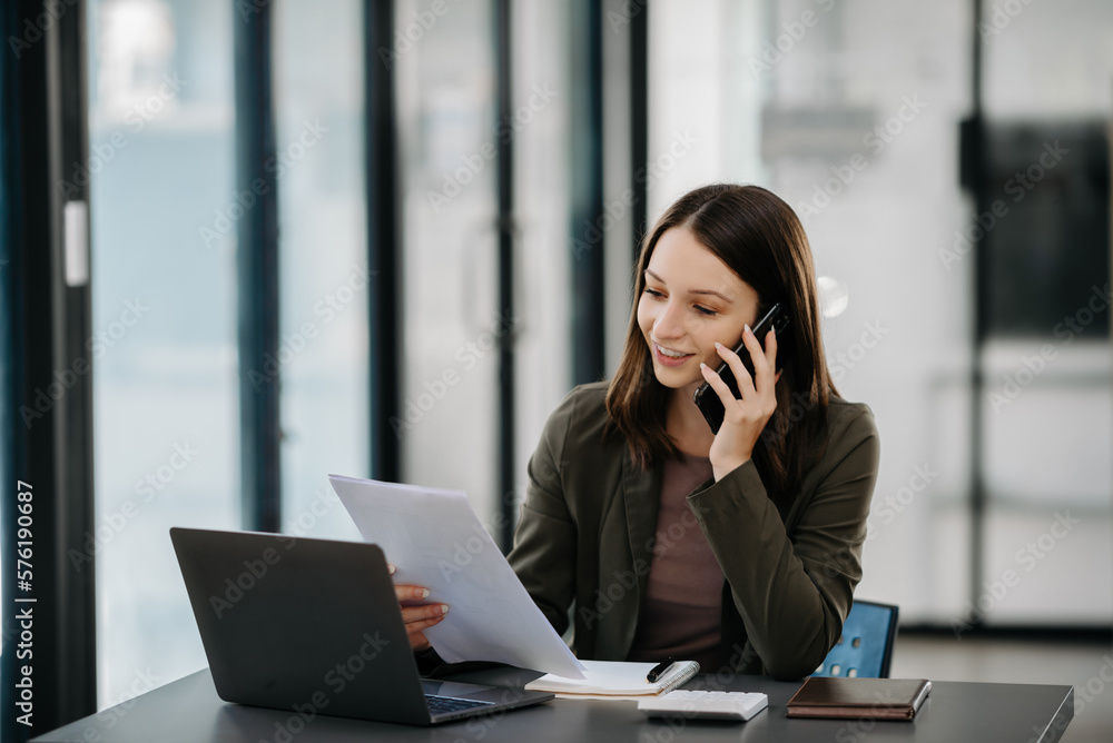 business documents on office table with smart phone and digital tablet and graph financial and woman working at office. business documents on office table with smart phone and digital tablet and graph financial and woman working at office.
