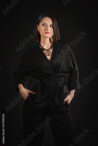 Mixed race brunette woman in black silk pajamas.