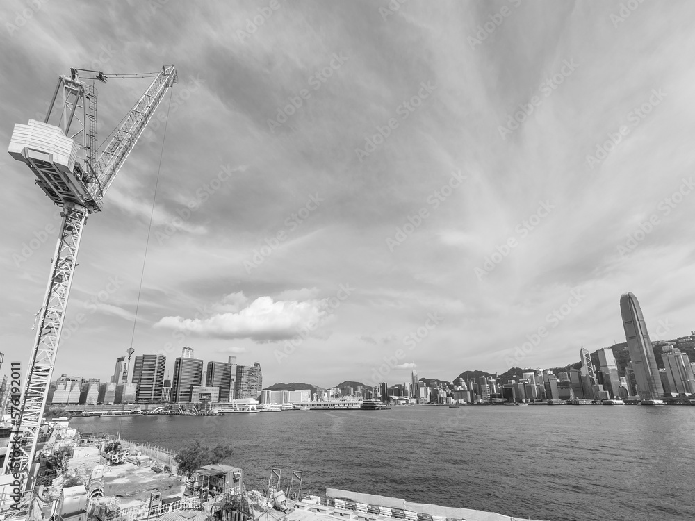 Crane in construction site and skyline of Hong Kong city