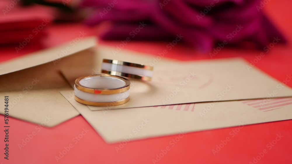 wedding ring and gift box and rose flower on red wedding ring and gift box and rose flower on red