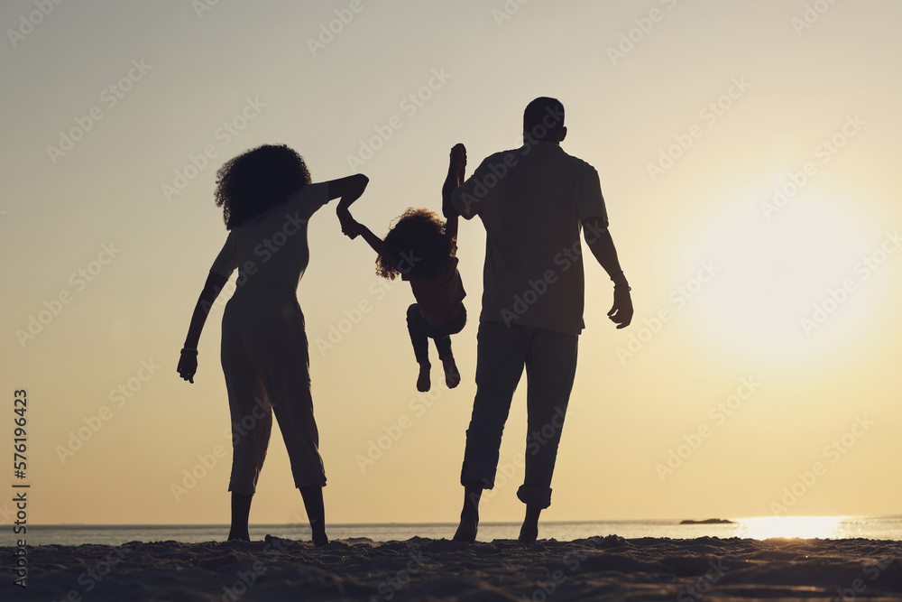 Fototapeta premium Silhouette, beach and a family with children by the ocean, playing together in nature at sunset from the back. Summer, travel or love with a mother, father and kid having fun while bonding at the sea