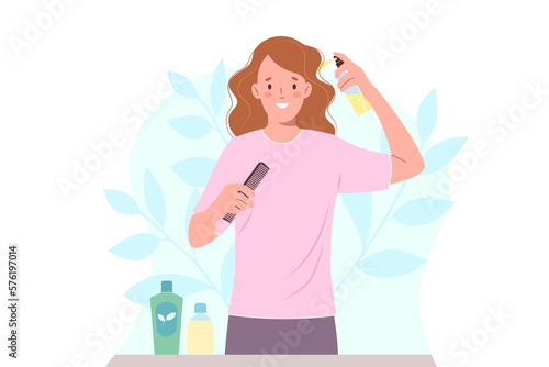 Woman takes care of her hair, applying moisturizing spray to curly hair.