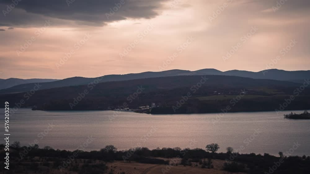 A Mesmerizing Timelapse of the Changing Hues and Serene Beauty of a Sunset Reflected on a Tranquil Lake