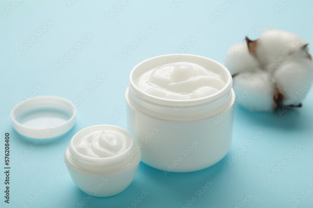 Face cream moisturizer in a jar on blue background. Luxury skincare cosmetics and anti-aging product for healthy skin and beauty routine Face cream moisturizer in a jar on blue background. Luxury skincare cosmetics and anti-aging product for healthy skin and beauty routine