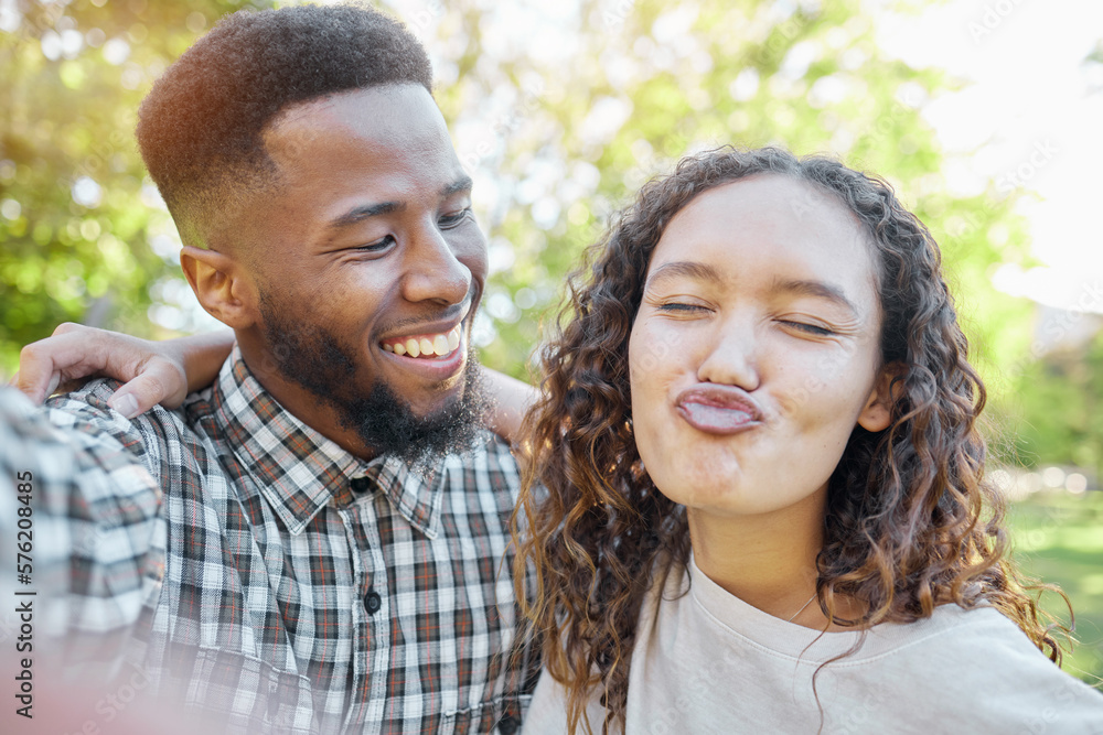 Couple of friends in selfie at park for summer holiday, happy date and funny face for social media. Diversity or interracial gen z or young people in nature with profile picture update and emoji kiss Couple of friends in selfie at park for summer holiday, happy date and funny face for social media. Diversity or interracial gen z or young people in nature with profile picture update and emoji kiss