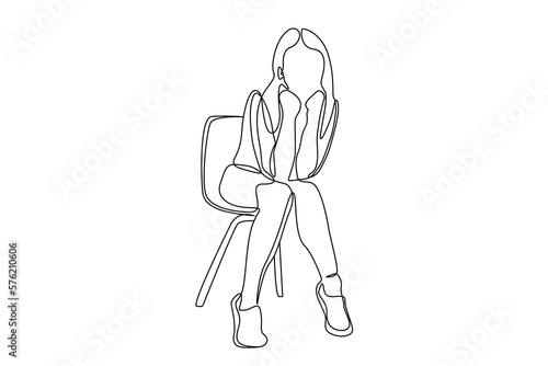 young beautiful thoughtful bored woman sitting on chair waiting