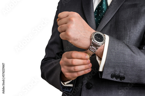 Businessman in black suit checking time from watch