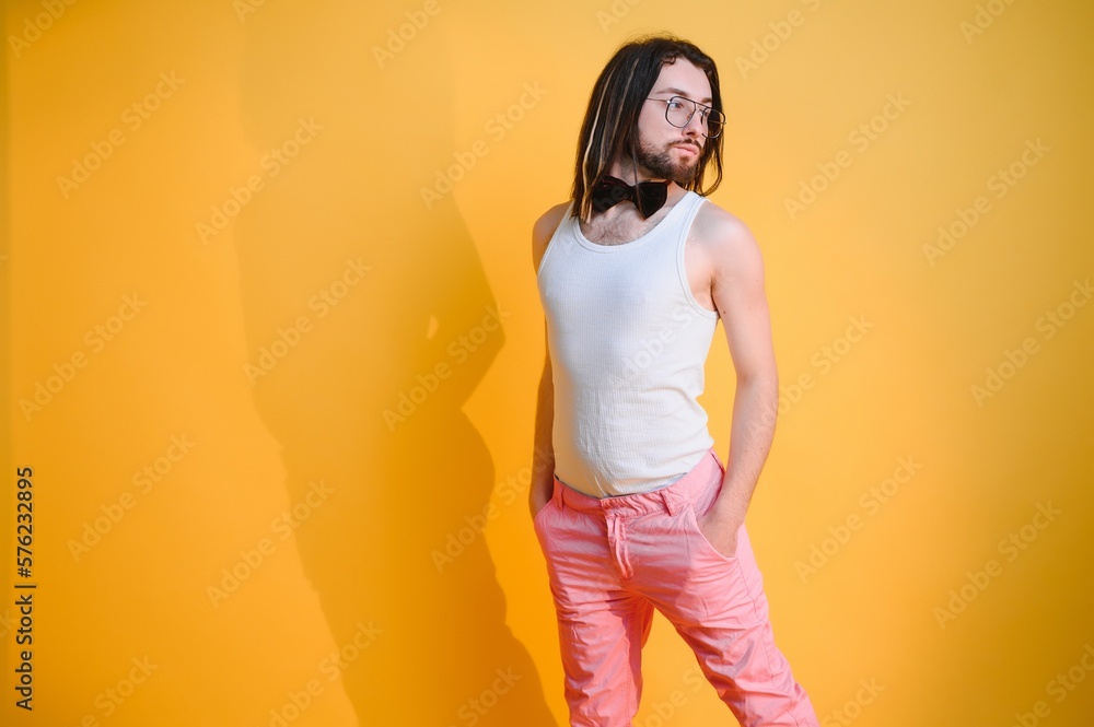 Gay man on a colored background in the studio. The concept of the LGBTQ community. Equality. Gay man on a colored background in the studio. The concept of the LGBTQ community. Equality.
