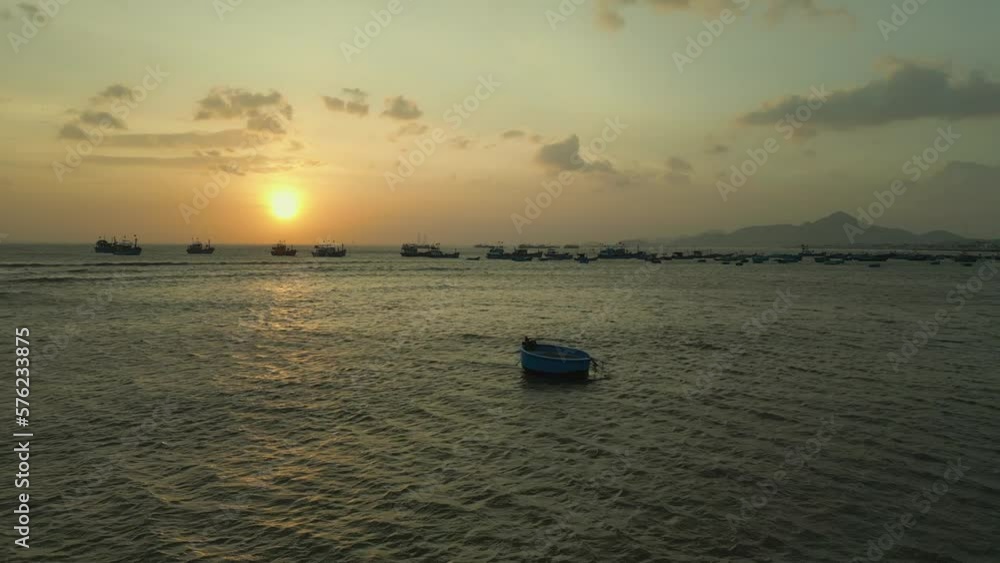 Sunset on the beach with fishing boats and fishermen casting fishing nets with gentle waves in Vietnam Sunset on the beach with fishing boats and fishermen casting fishing nets with gentle waves in Vietnam