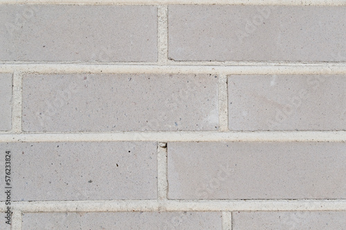 Light gray brick wall. Grunge brick wall texture background. Close-up picture of brick wall. 
