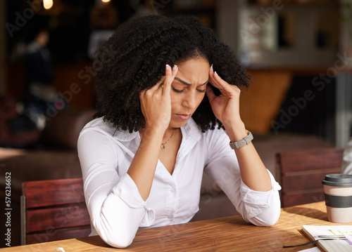 Business stress, headache and black woman in coffee shop feeling pain, migraine or tired. Mental health, anxiety and remote worker or female employee with depression, burnout or fatigue in restaurant