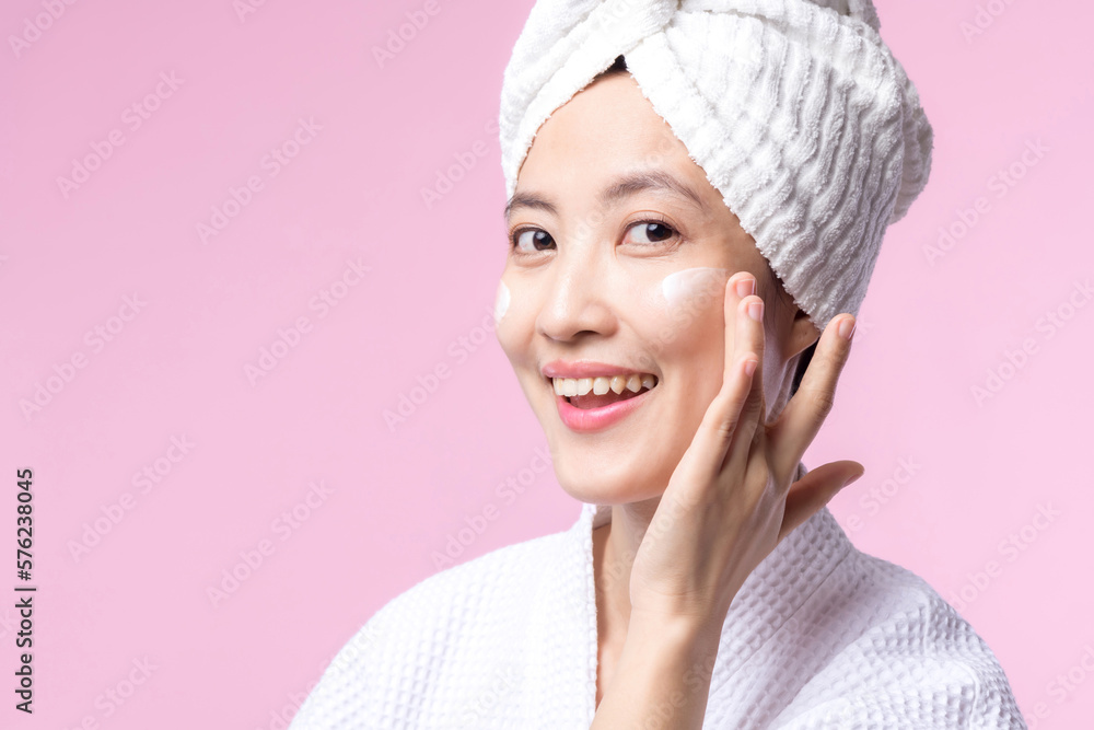 Young asian woman applying facial skincare face cream, cosmetic moisturiser on healthy natural skin make up face. Portrait glowing smile girl person model with care beauty product, spa, cosmetology. Young asian woman applying facial skincare face cream, cosmetic moisturiser on healthy natural skin make up face. Portrait glowing smile girl person model with care beauty product, spa, cosmetology.