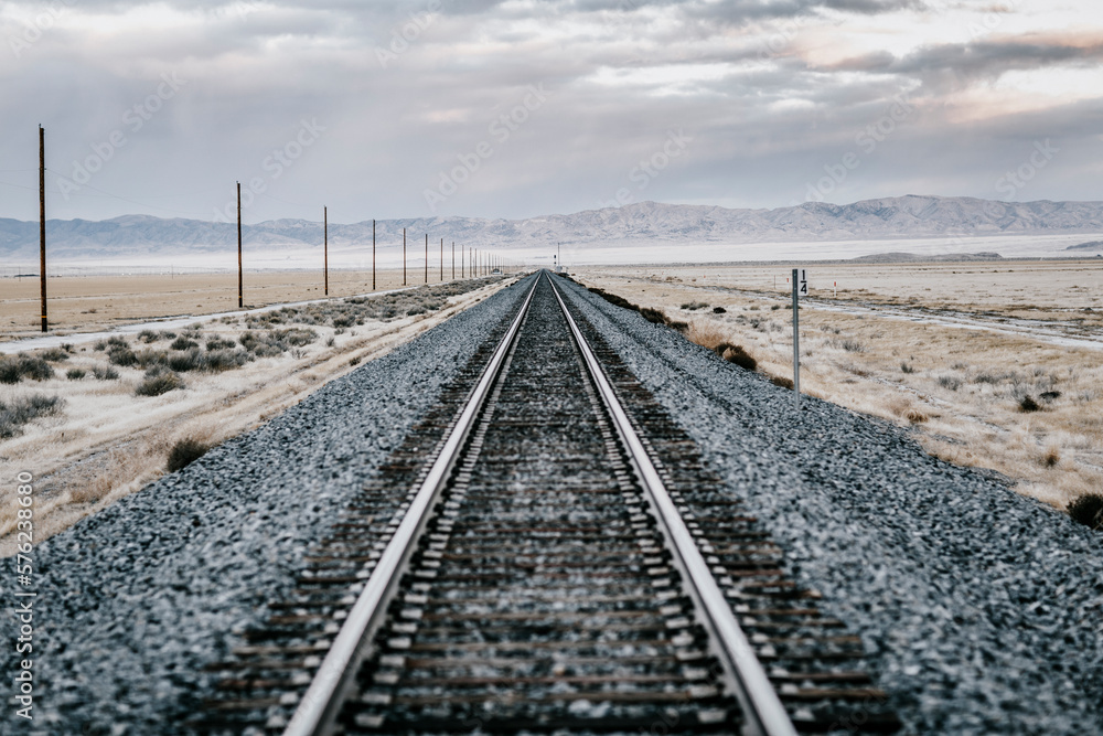 Railroad tracks crossing barren desert, Salt Lake City, Utah, USA Railroad tracks crossing barren desert, Salt Lake City, Utah, USA