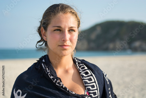 Portrait Of A Young Woman Wearing A Blue Pashmina On The Beach photo