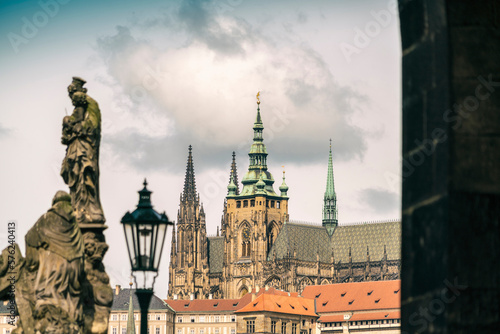 View from Charles bridge with statues with the Prague Castle and St. Vitus Cathedral in the background photo
