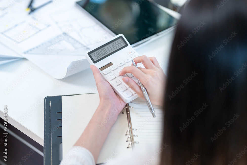 Professional Asian female architect or engineer using scientific ...