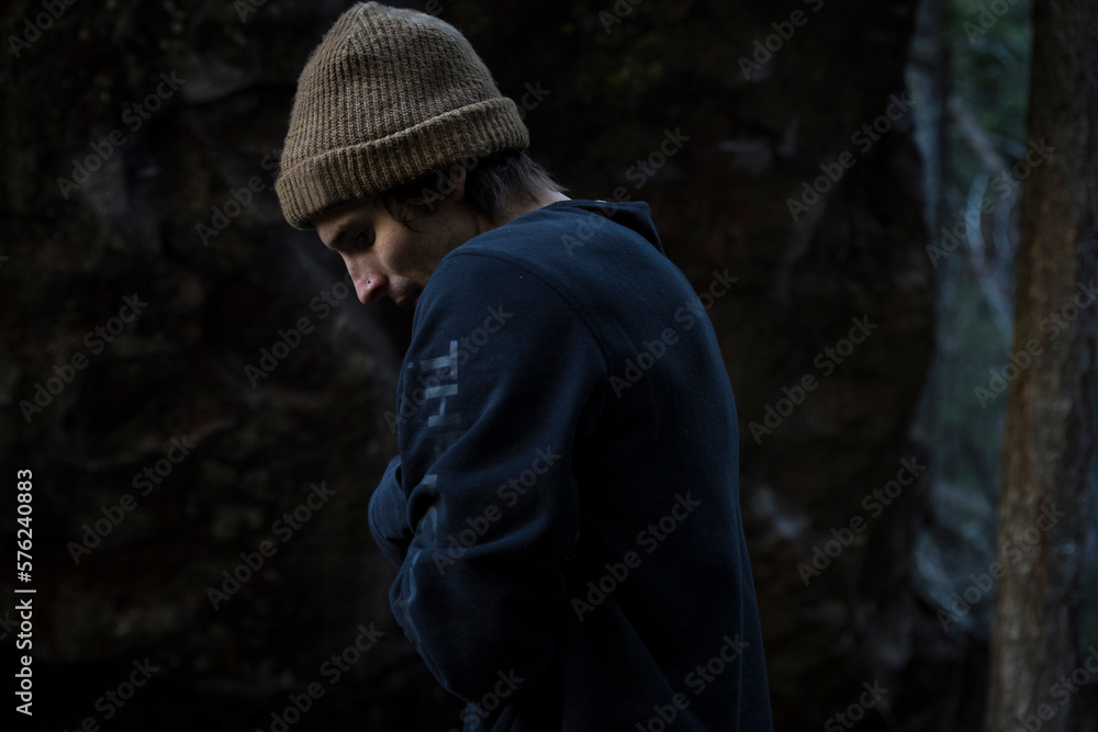 Man in knit hat and sweatshirt standing outdoors in cold Man in knit hat and sweatshirt standing outdoors in cold